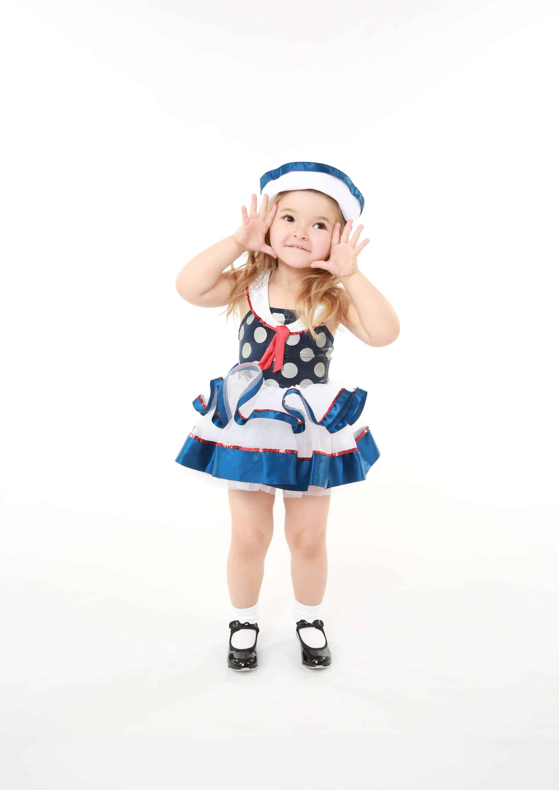 Young girl posing in a navy polka dot sailor-themed recital costume at Shooting_Stars in Santa Clarita