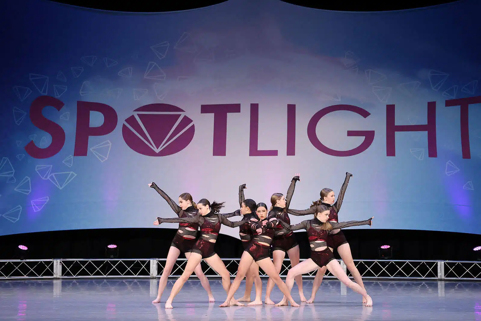 Empire Dance Center group performance on stage beneath the Spotlight competition banner.